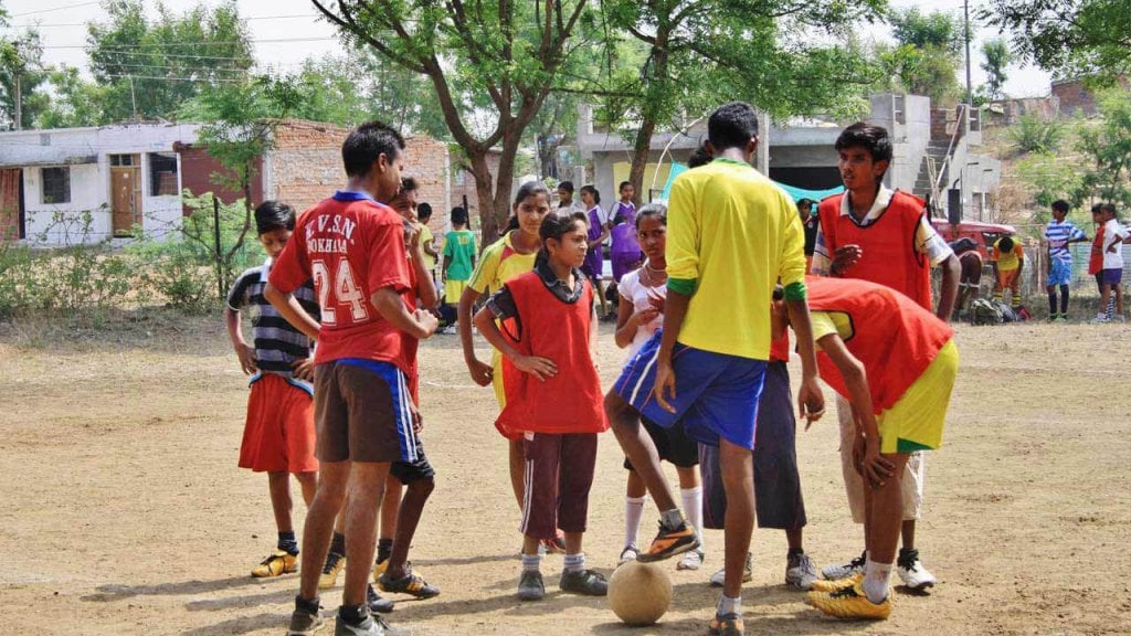 Young people playing football in India